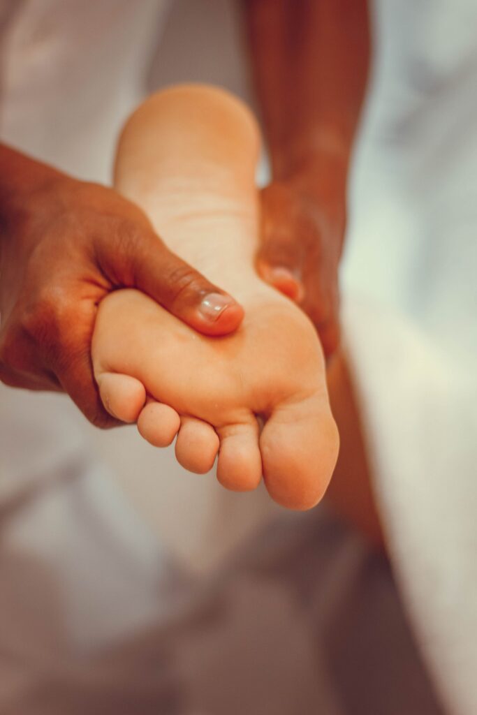 Reflexologist working carefully on a client's foot